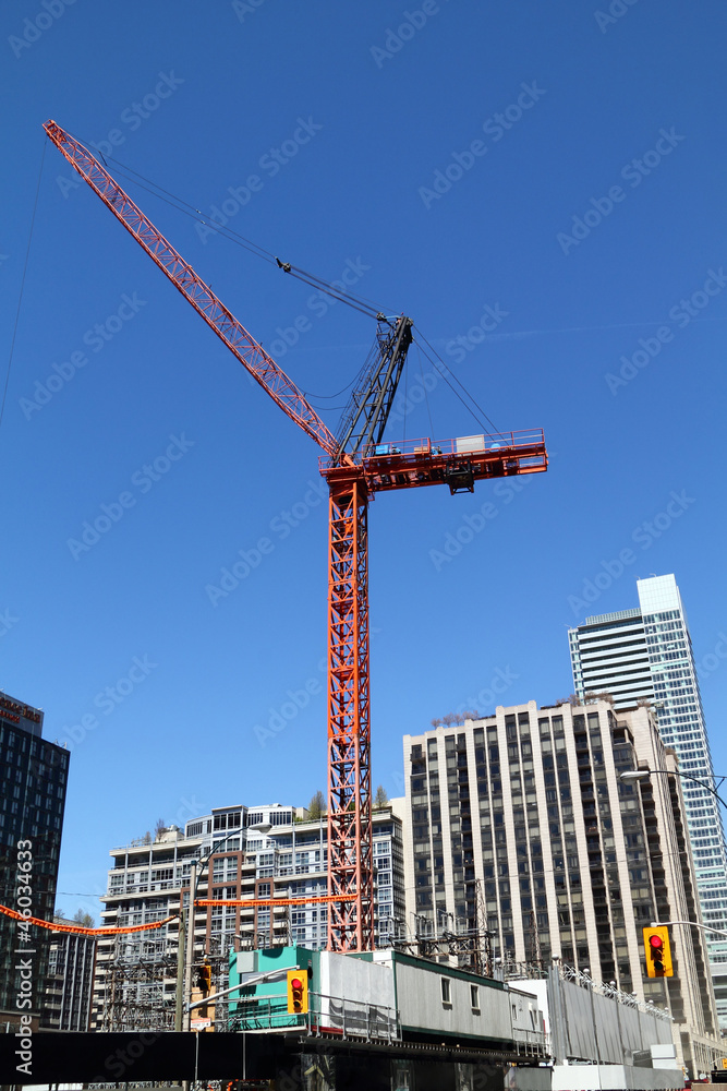 high-rise building crane on top of building