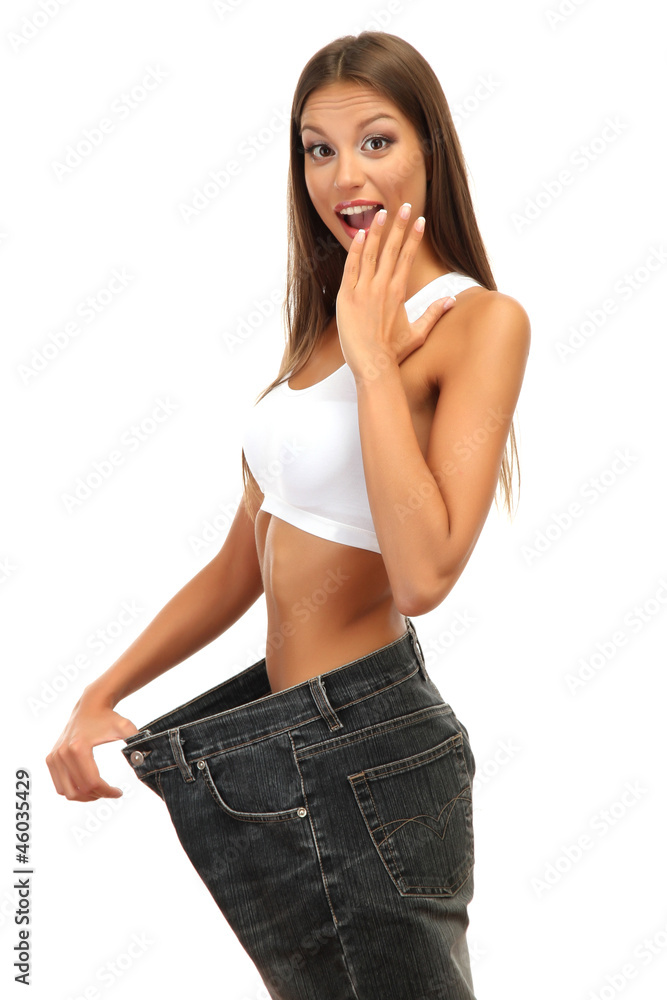 beautiful young woman with big jeans, isolated on white beautiful young woman with big jeans, isolated on white