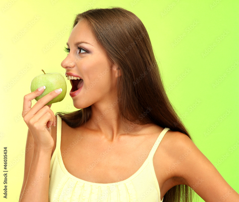 beautiful young woman with green apple, on green background beautiful young woman with green apple, on green background