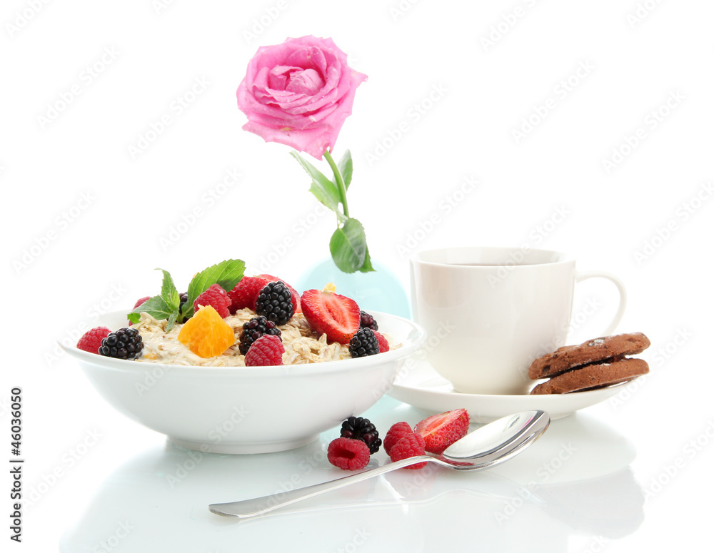 tasty oatmeal with berries and cup of tea, isolated on white tasty oatmeal with berries and cup of tea, isolated on white