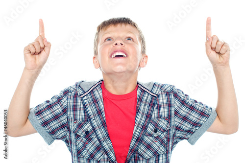 Smiling young child looking up and pointing