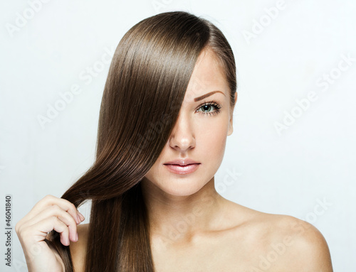 portrait of a beautiful young woman with elegant long shiny hair