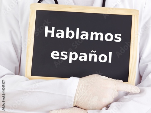 Doctor shows information: we speak spanish