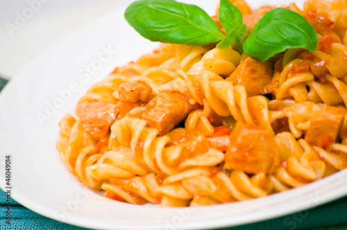 Fusilli pasta with chicken breast in tomato sauce