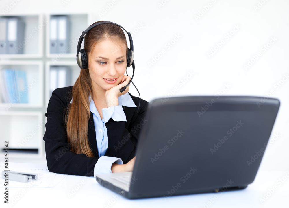 pretty young female operator sitting at office desk with headset pretty young female operator sitting at office desk with headset