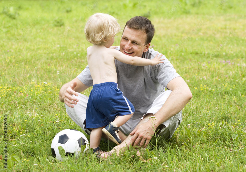 father playing football with his son father playing football with his son
