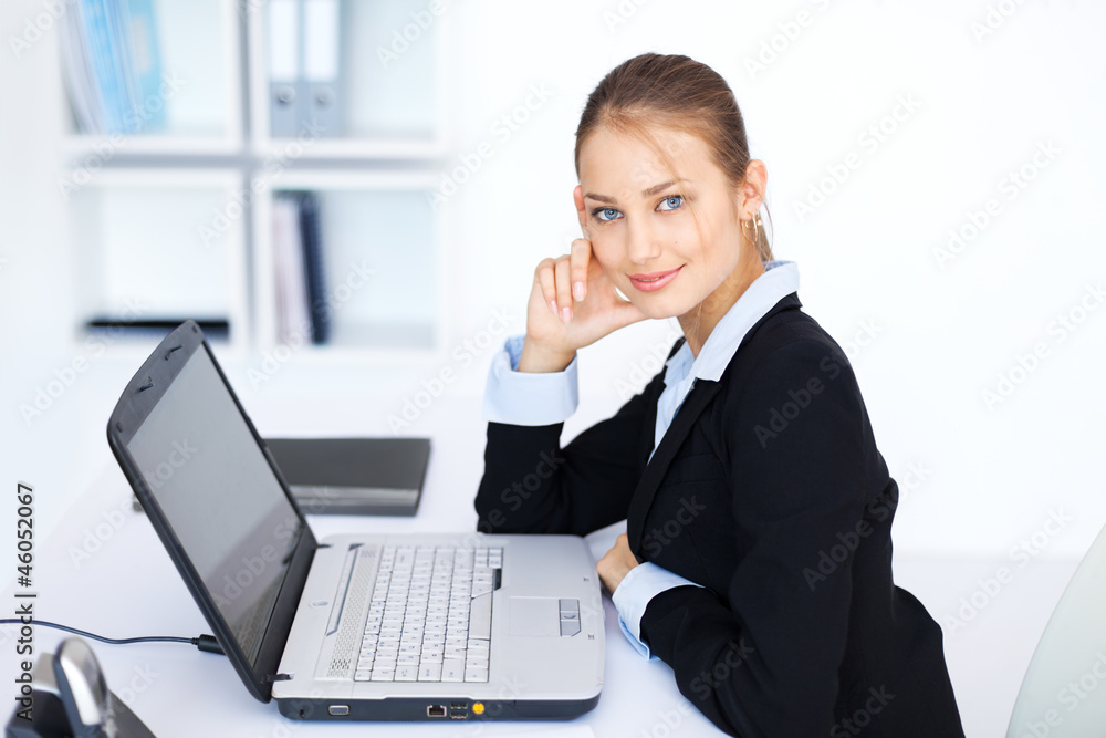 beautiful young smiling business woman working on a laptop beautiful young smiling business woman working on a laptop