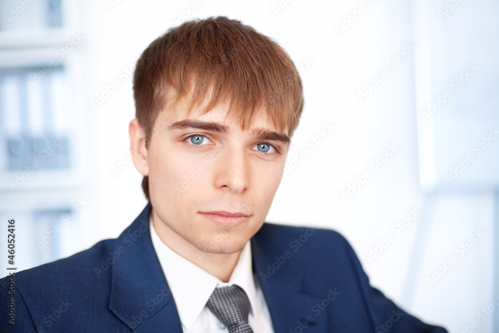 portrait of young businessman in office portrait of young businessman in office