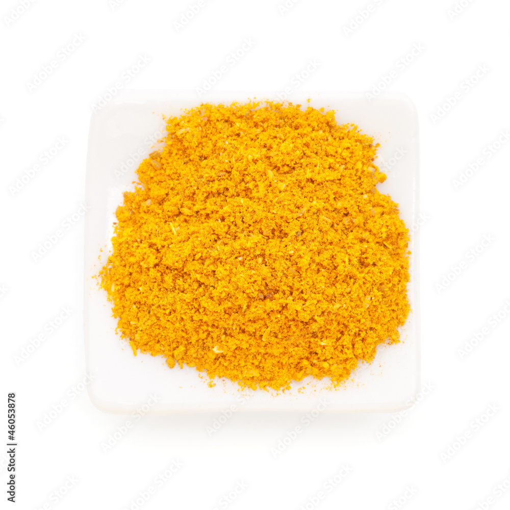 Curry ground (Madras Curry) in a white bowl on white background. Curry ground (Madras Curry) in a white bowl on white background.