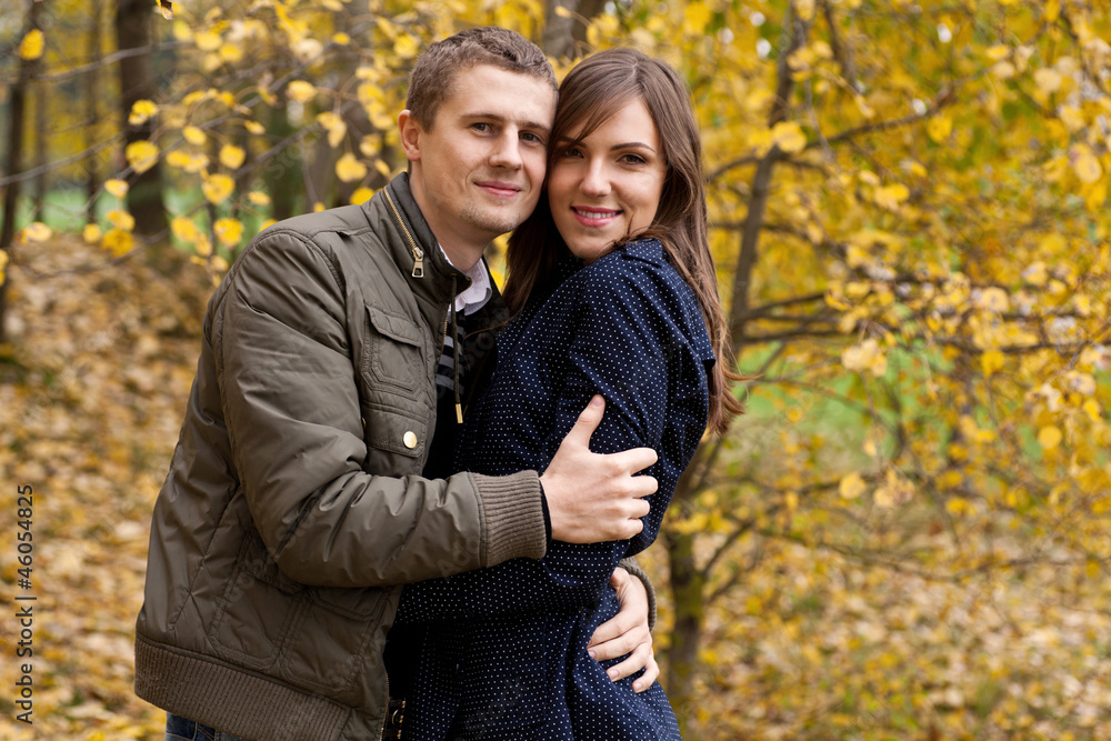 young couple in autumn park young couple in autumn park