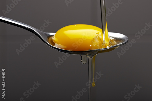 Egg yolk on a silver spoon