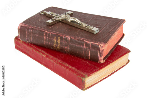 Old antique bible and cross on a white background