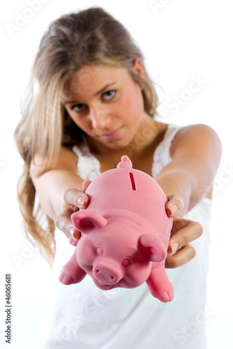 Saving, blonde young woman with a piggy bank