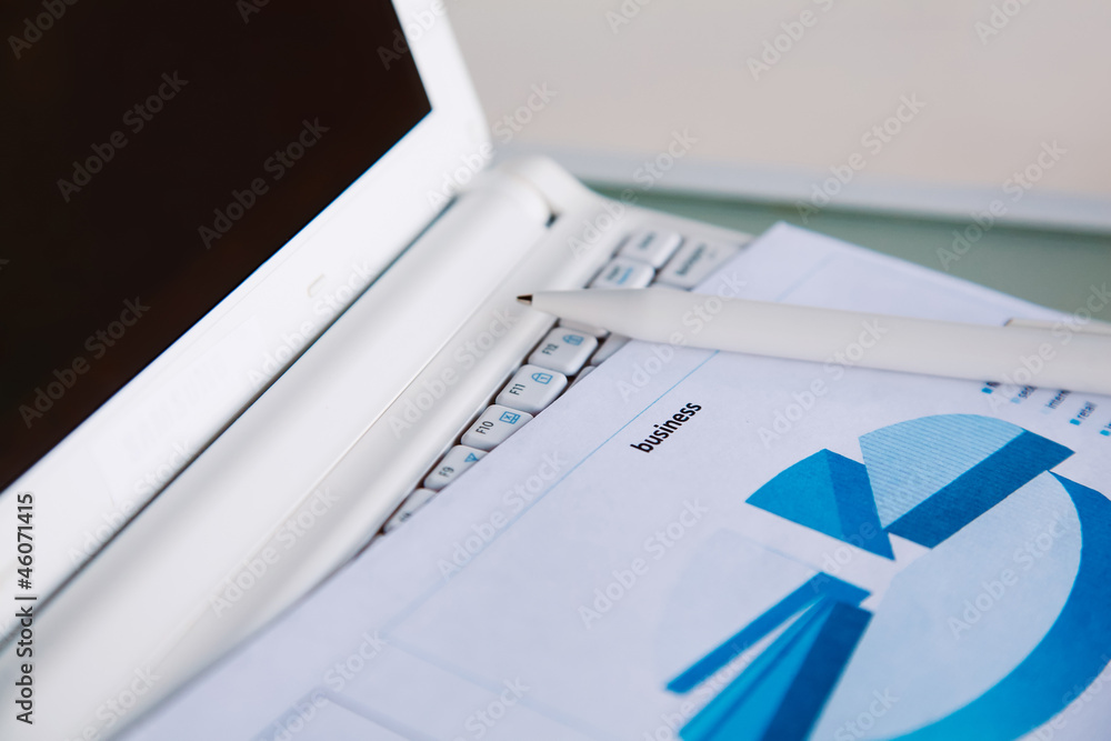 Papers on a laptop Papers on a laptop