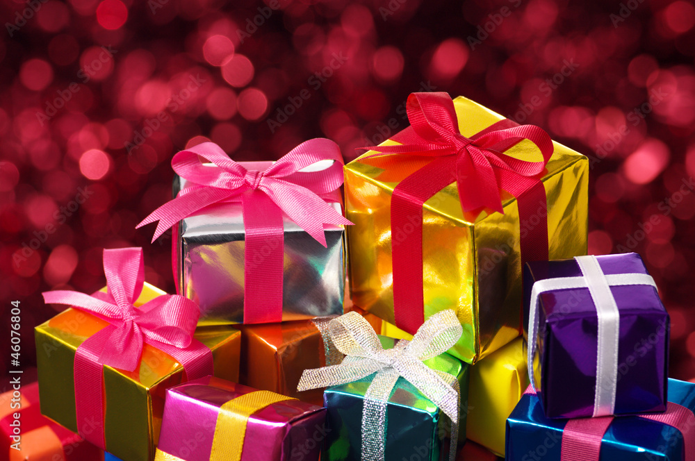 Pile of small gifts on red blurry lights background. Pile of small gifts on red blurry lights background.