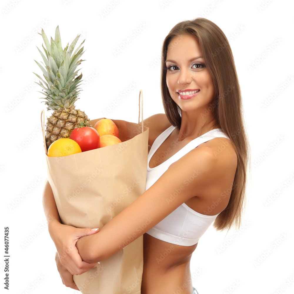beautiful young woman with fruits in shopping paper bag,