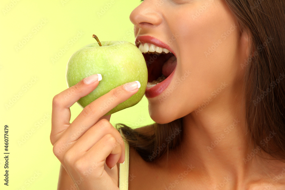 beautiful young woman with green apple, on green background beautiful young woman with green apple, on green background