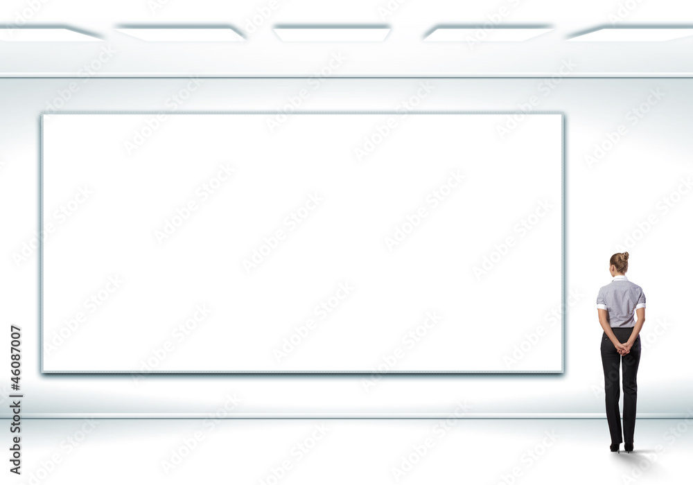 Business person standing near a blank billboard Business person standing near a blank billboard