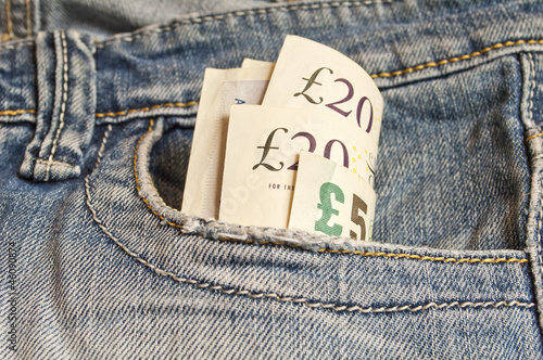 Few British pounds in a jeans pocket