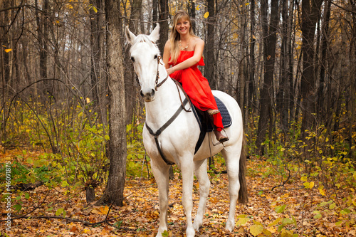 fine young woman on horseback on white horse