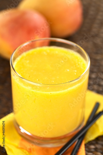 Fresh homemade mango juice in glass with straws