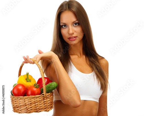 beautiful young woman with vegetables in basket, isolated © Africa Studio