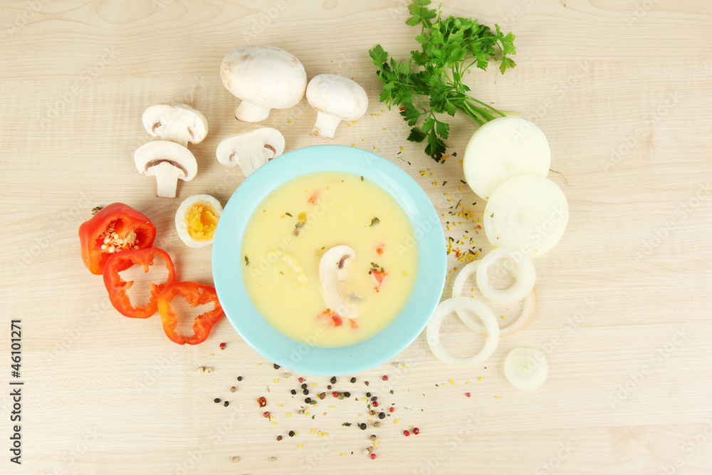 Fragrant soup in blue bowl with ingredients around Fragrant soup in blue bowl with ingredients around