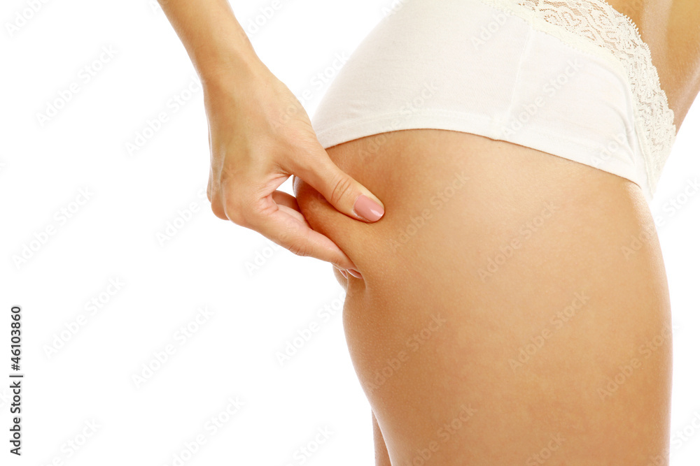A young woman pampering cellulite skin