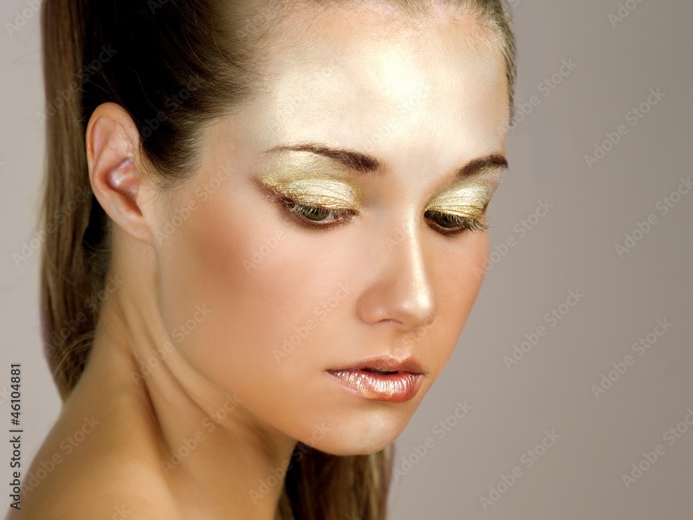 Gold Makeup.Fashion Girl Portrait Gold Makeup.Fashion Girl Portrait