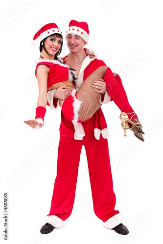 Happy young couple wearing santa claus clothes