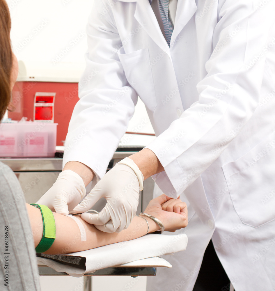 A doctor with patient in a process of blood checking