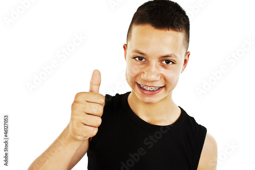 Portrait of a teenage boy with thumbs up on a white background