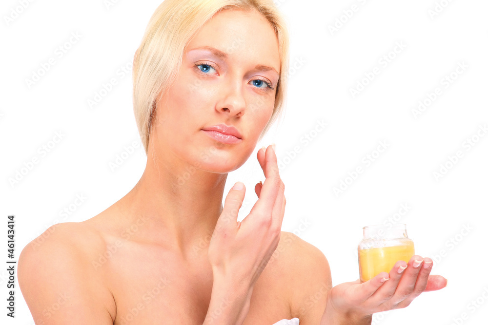 A woman applying cream on face, isolated on white A woman applying cream on face, isolated on white