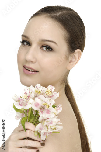 Portrait of woman with branch pink orchids