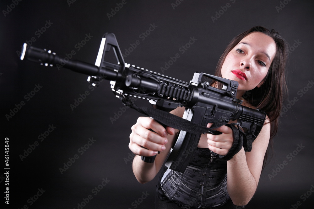 Girl holding Rifle on black background Girl holding Rifle on black background