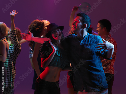girl and guy dancing and smiling at party