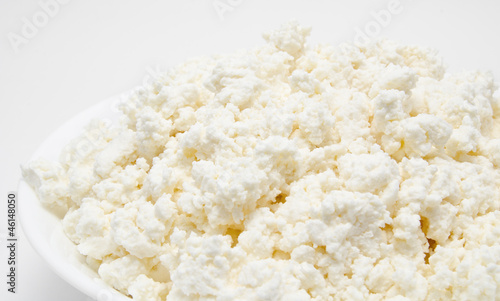 Fresh cottage cheese in the bowl isolated