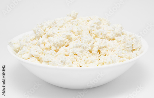 Fresh cottage cheese in the bowl isolated