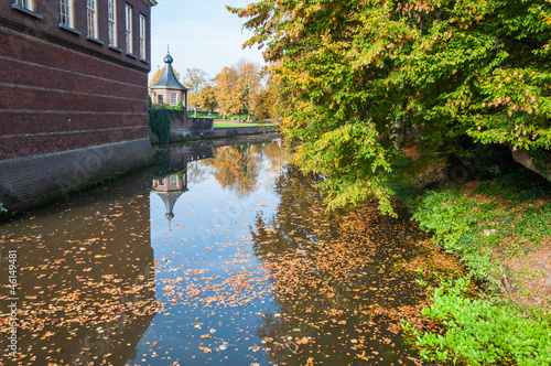 Fototapeta Naklejka Na Ścianę i Meble -  Autumn leaves floating in an old canal