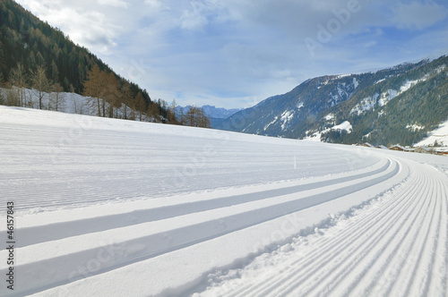 Snowy mountain landscape with cross country track