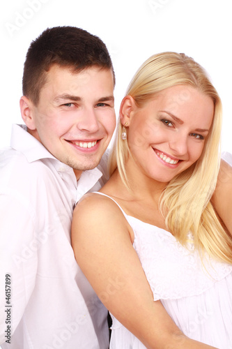 Portrait of young couple in love smiling on white background 