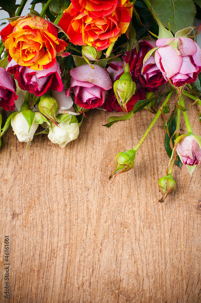 multicolored roses on a wooden board