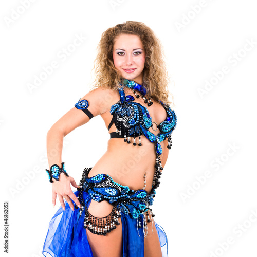 Attractive belly dancer dressed in a blue costume dancing