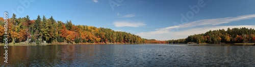 Panoramic photo of lake and autumn forest.