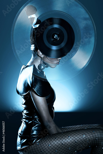 Attractive african woman with vinyl record on head
