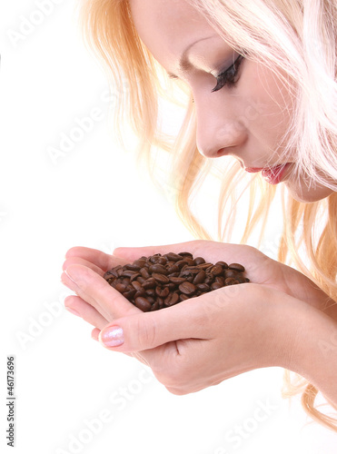 blonde young woman smelling coffee beans isolated