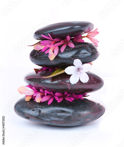 spa stones with white and hot pink flowers isolated on white