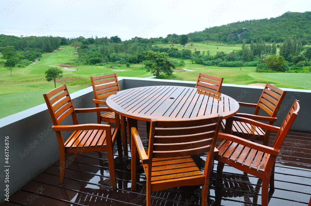 Chairs and table on wooden in a Green grass on a golf field