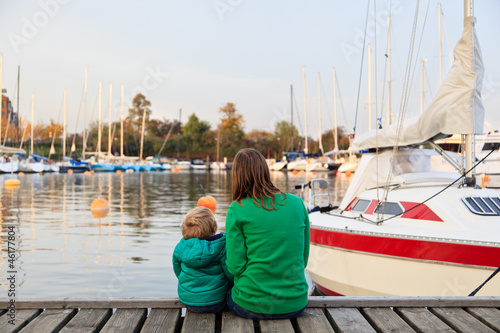 Photography family sitting on pier