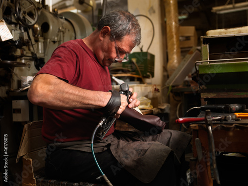 adult man working in a shoe factory